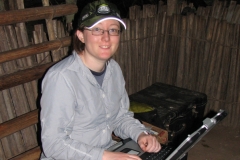 Christina Bergey working on a laptop in Obenge, Democratic Republic of Congo. (Photo by Kate Detwiler.)