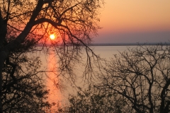 The sun setting over Lake Itezhi-Tezhi as seen from Chibela Camp in Ngoma.